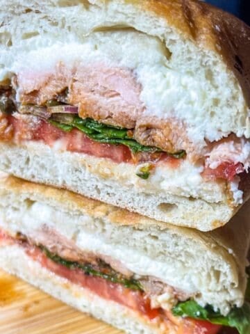 Smoked salmon Sandwich stacked on board.