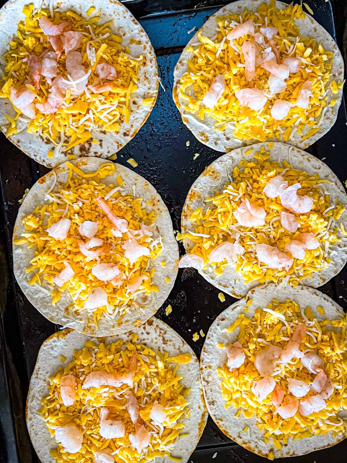 shrimp and cheese laid over 6 tortillas to make quesadillas.