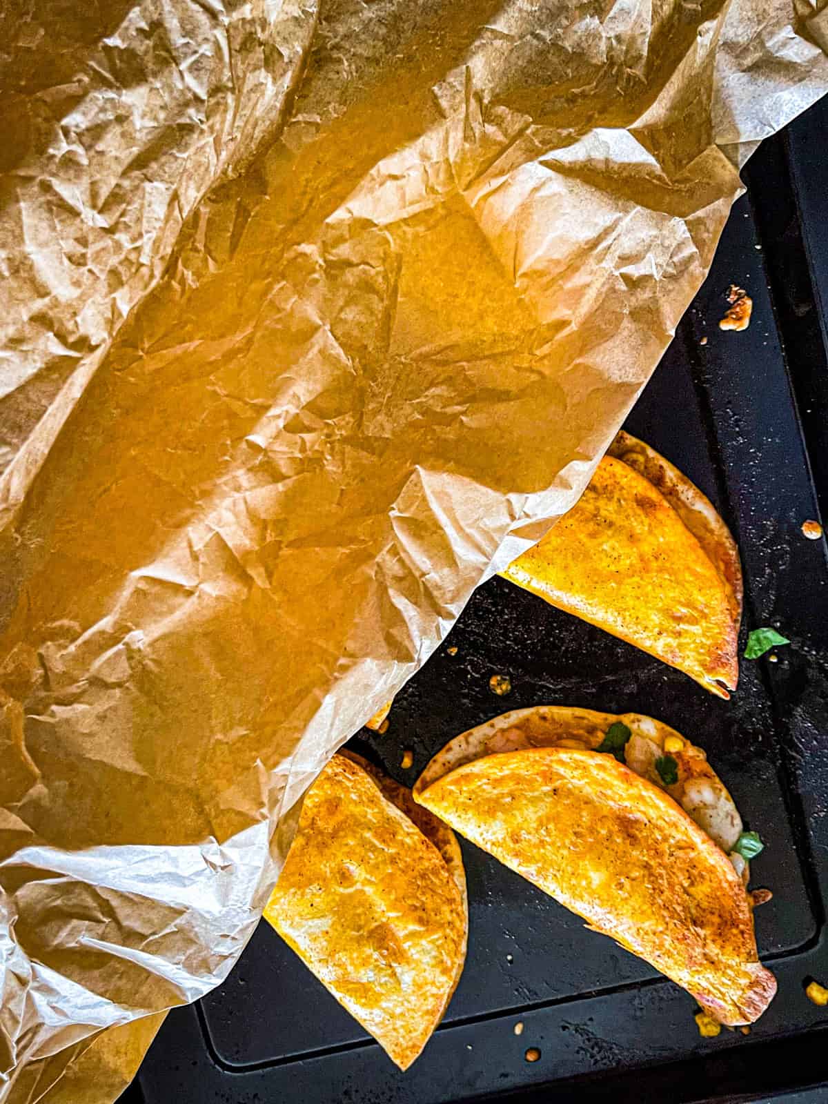 Parchment paper over quesadillas.