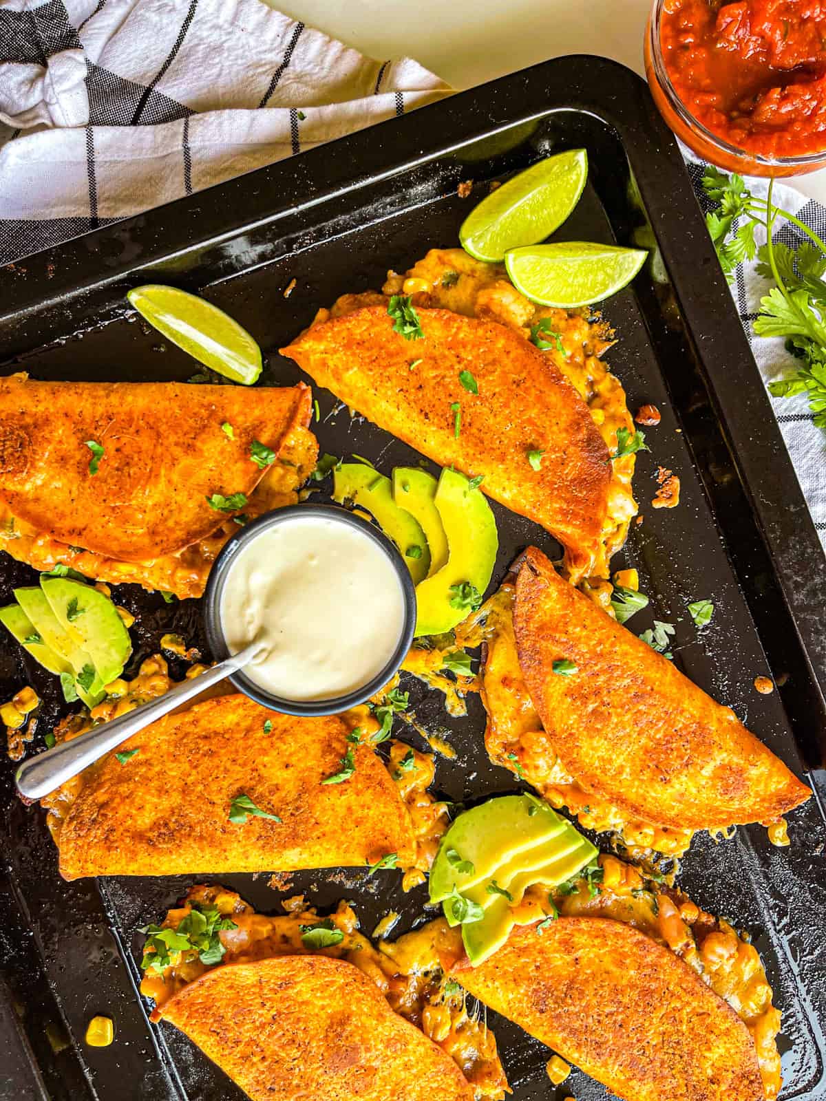 Quesadillas laid out on a sheet pan.
