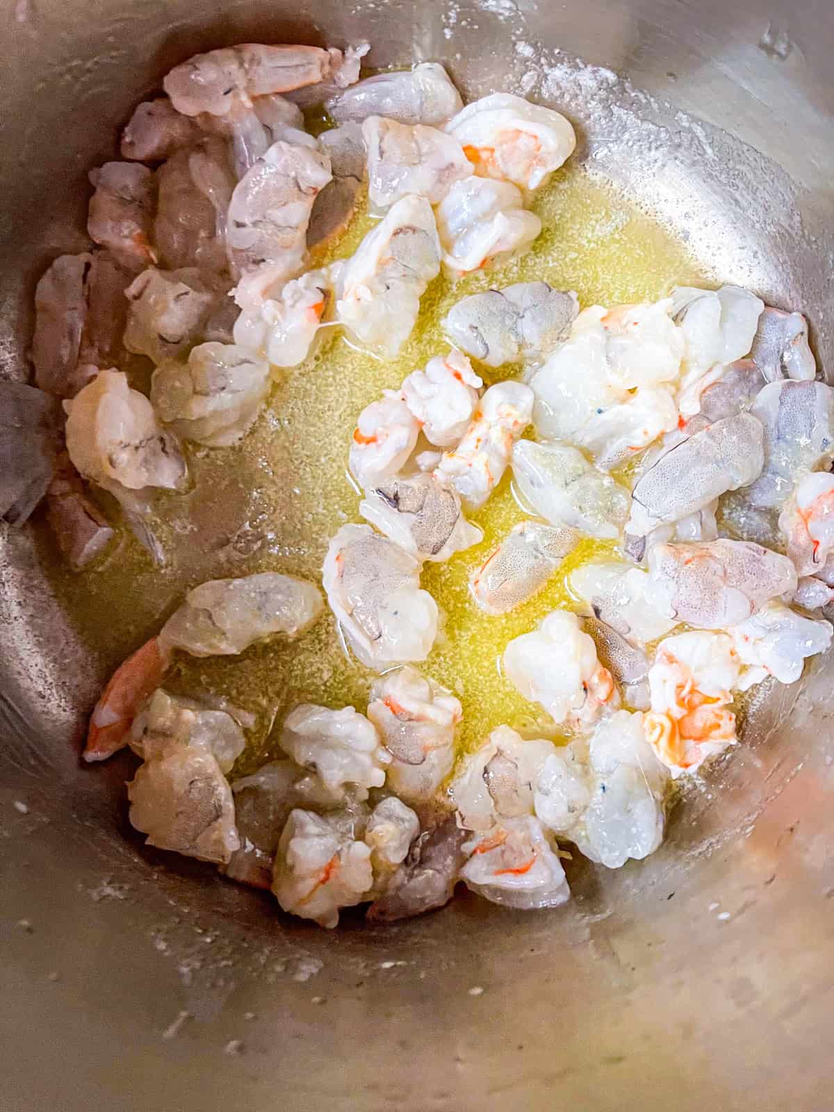 shrimp cooked in butter in a pot.