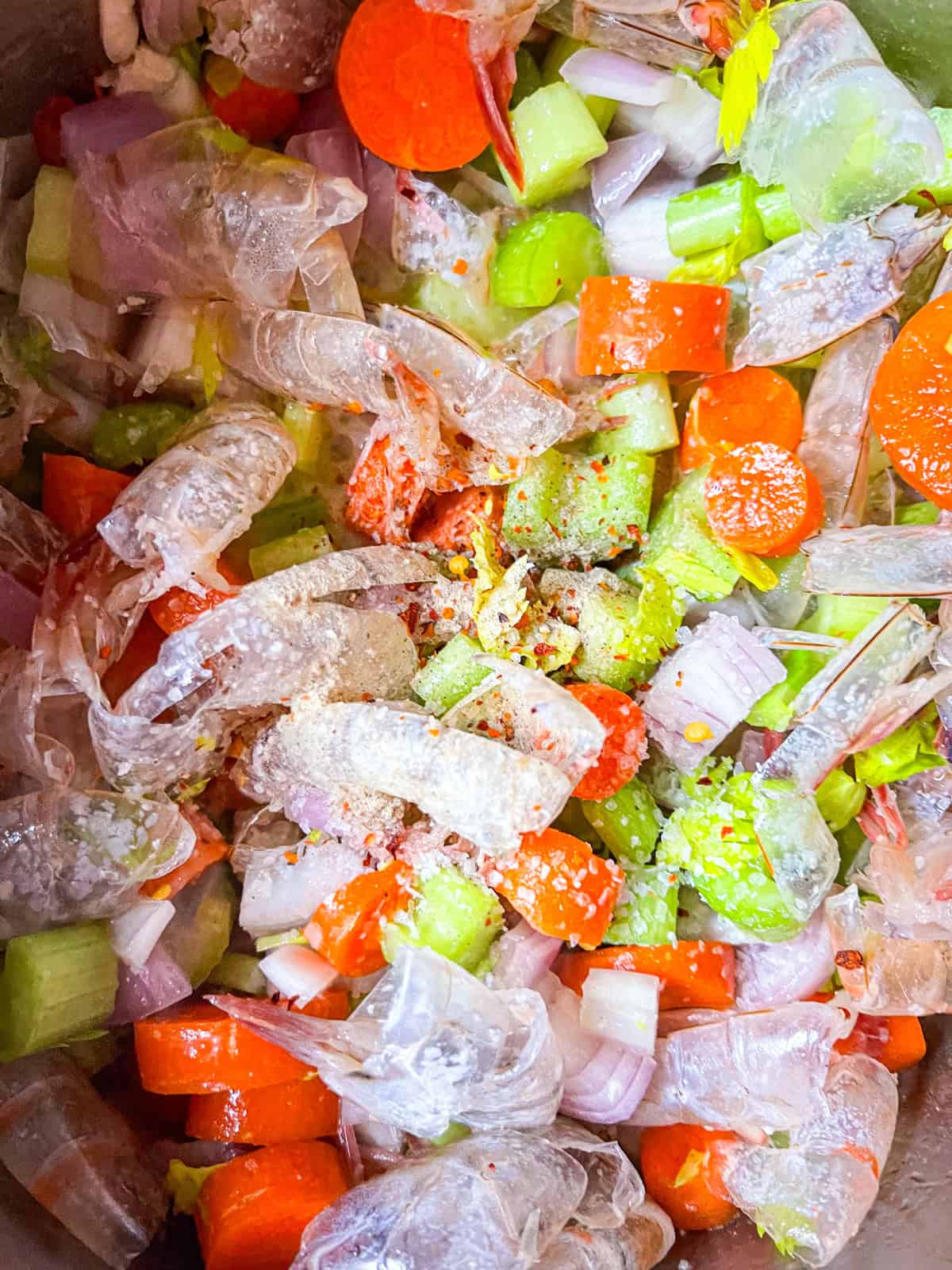 vegetables and shrimp shells cooked in a pot.