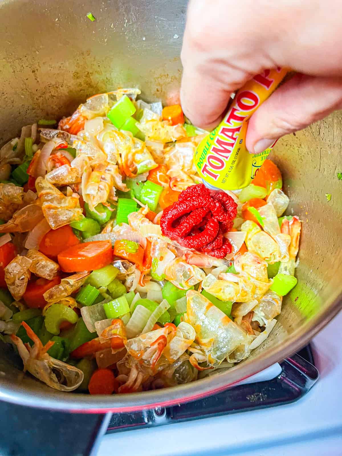 Tomato paste added to vegetables and shells.