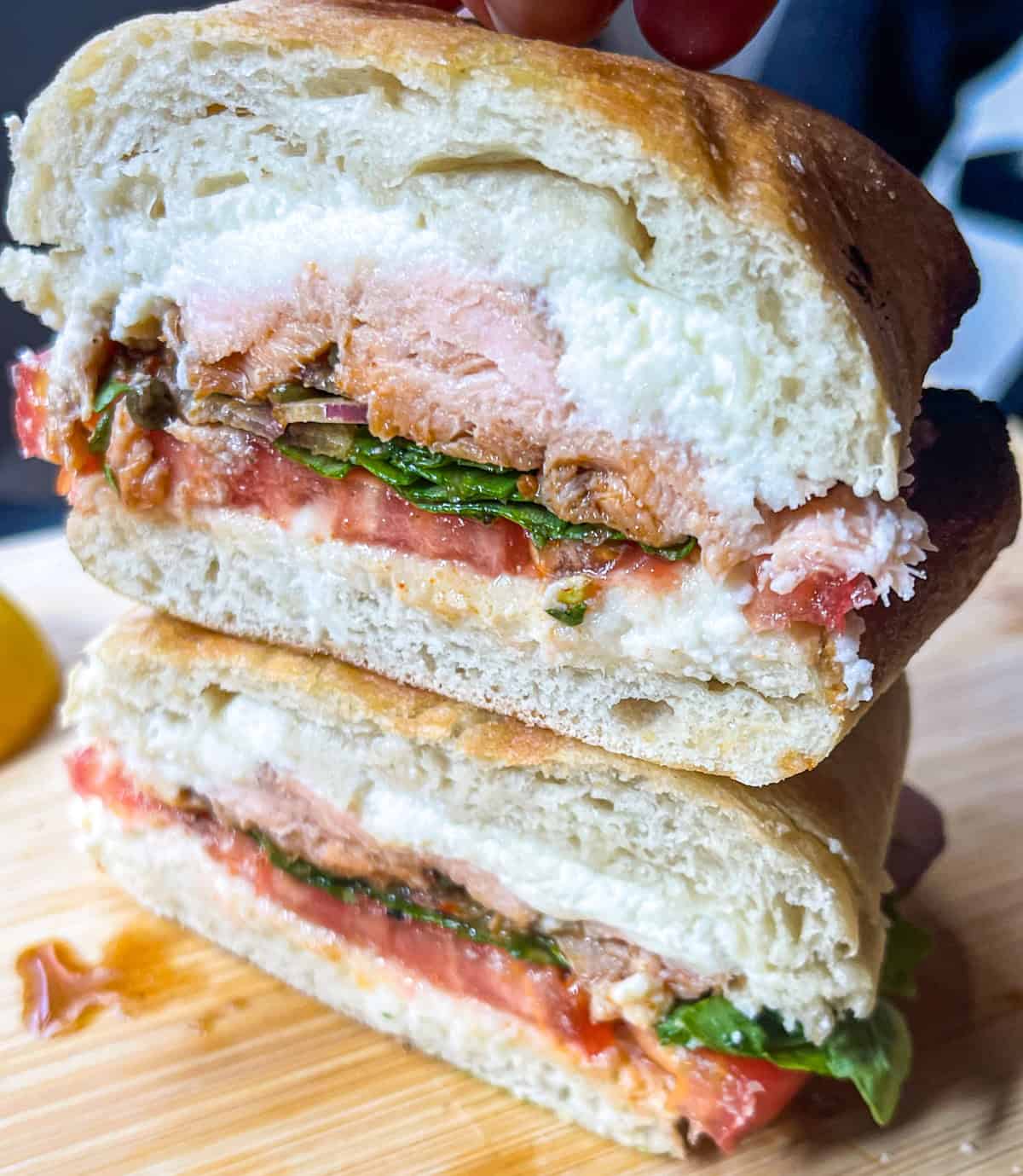 Smoked salmon Sandwich stacked on board.