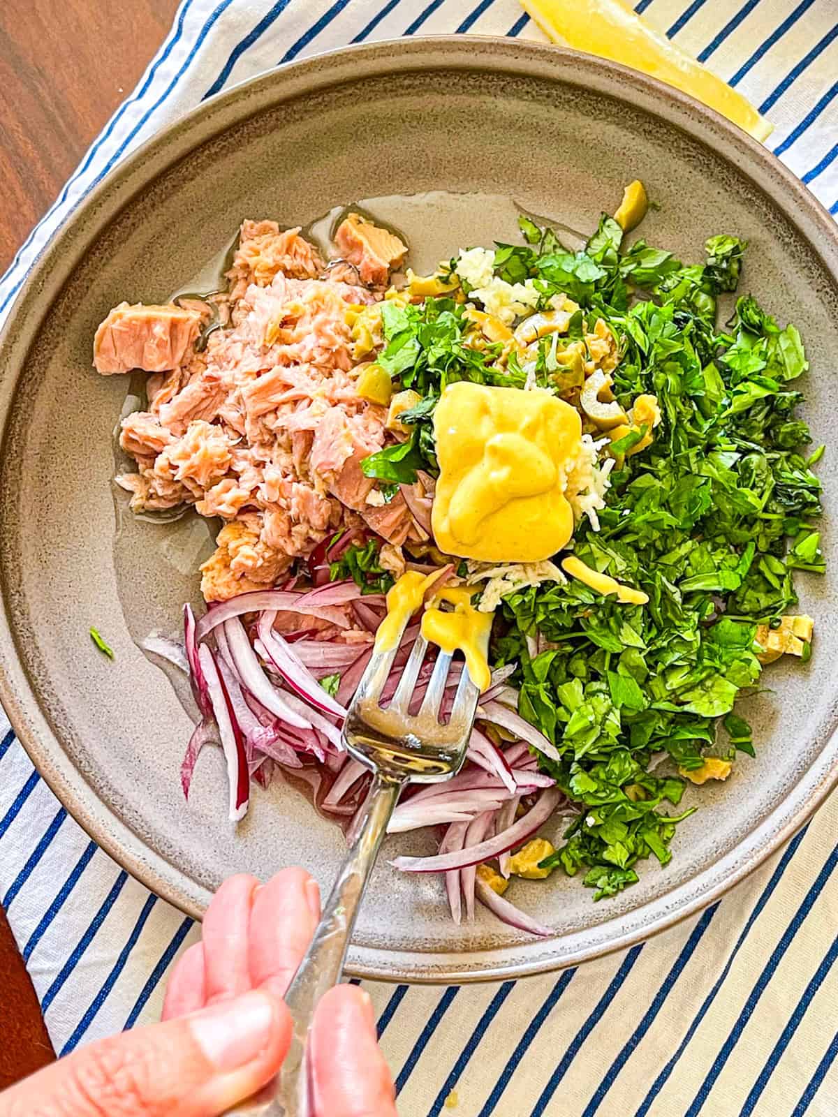 Ingredients for tuna melt filling mixed in a bowl.