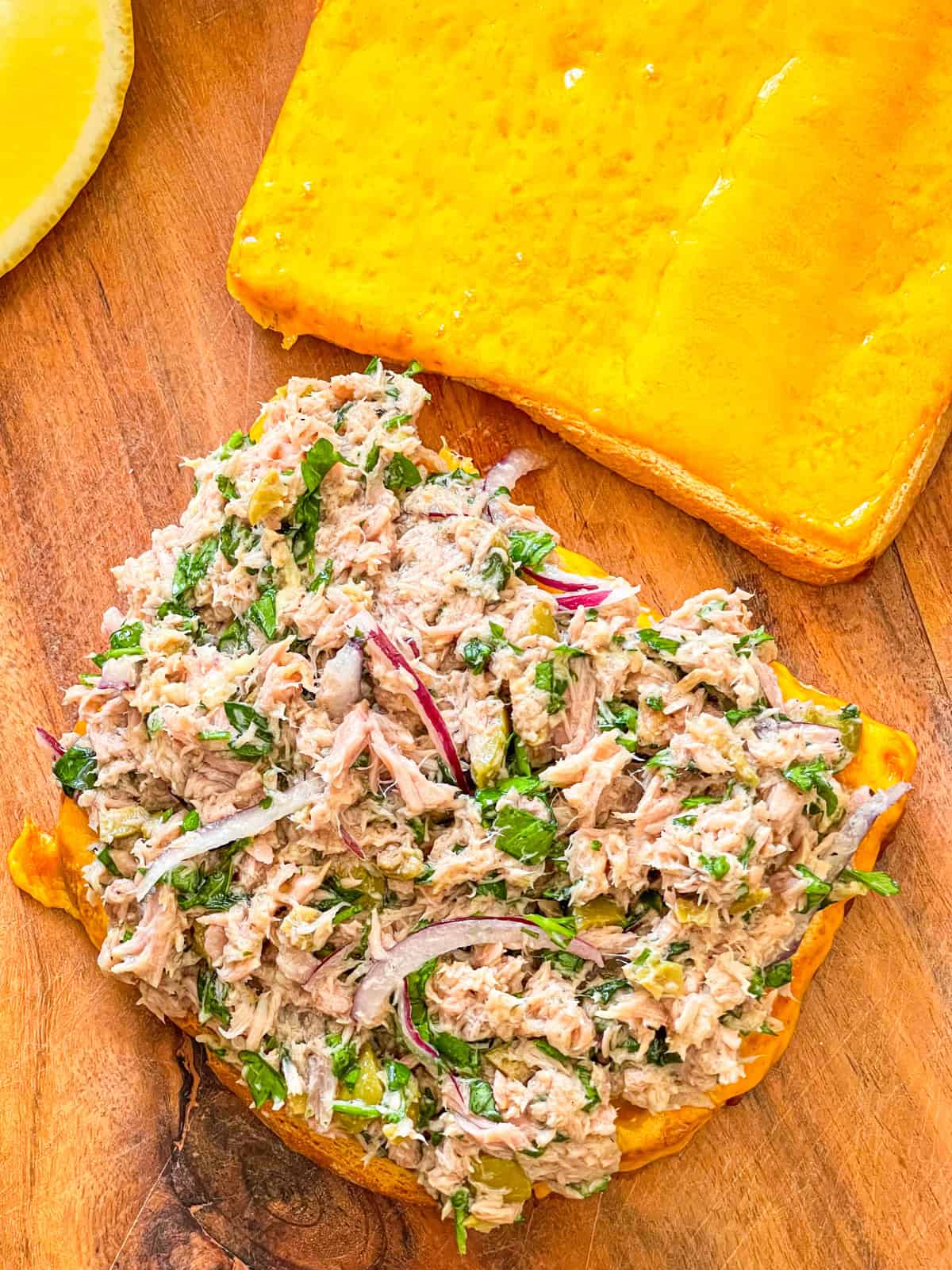 Tuna salad piled on top of cheesy bread.
