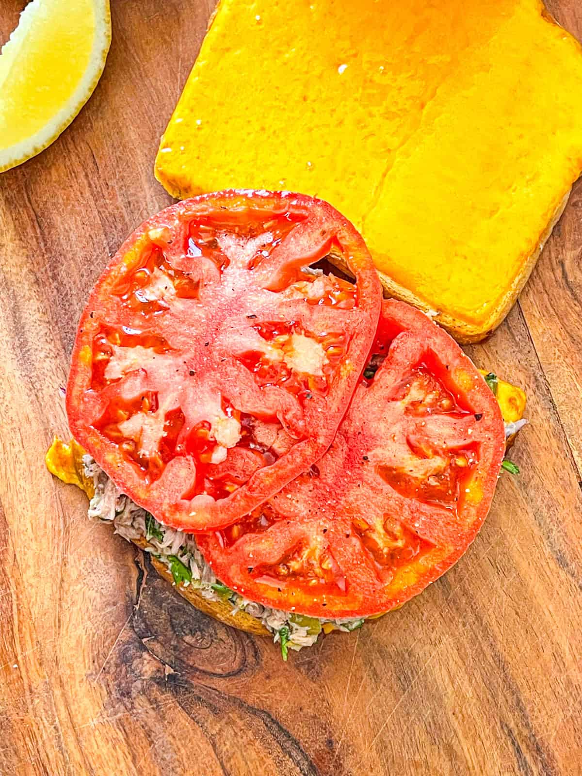 tomato places onto tuna melt and bread