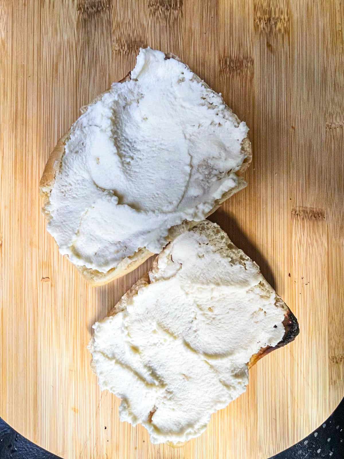 Cream cheese spread over two slices of bread