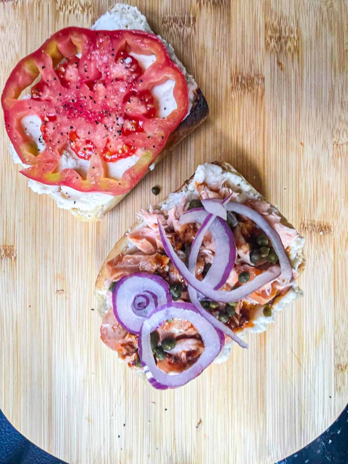 Smoked salmon, tomato, onions , cream cheese spread on two slices of bread