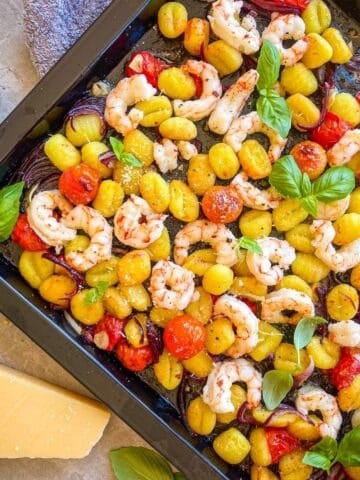 Sheet pan full of shrimp, gnocchi.
