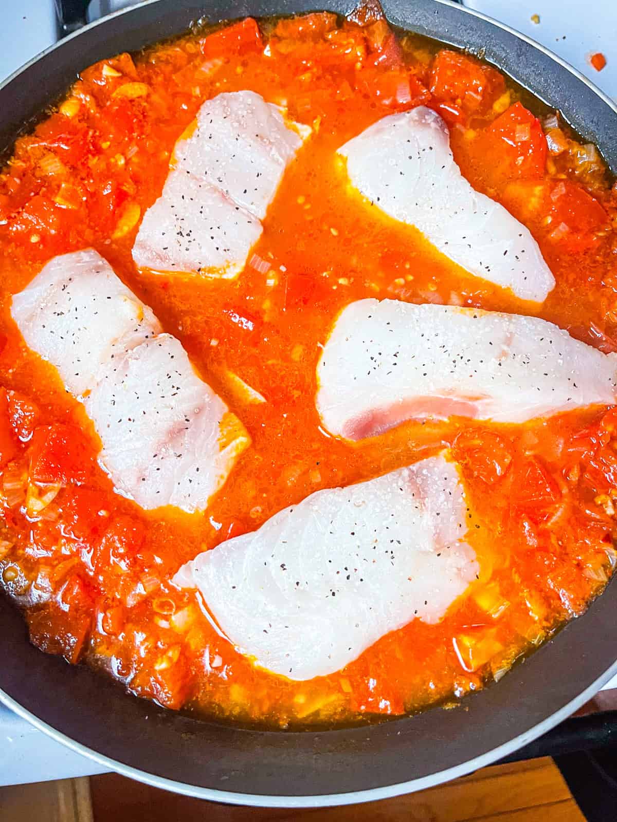 Fish poached in tomato sauce.