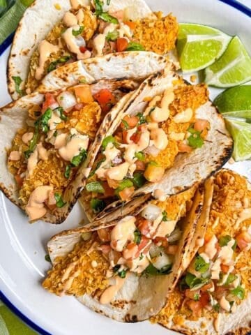 5 Fish Tacos on a plate.