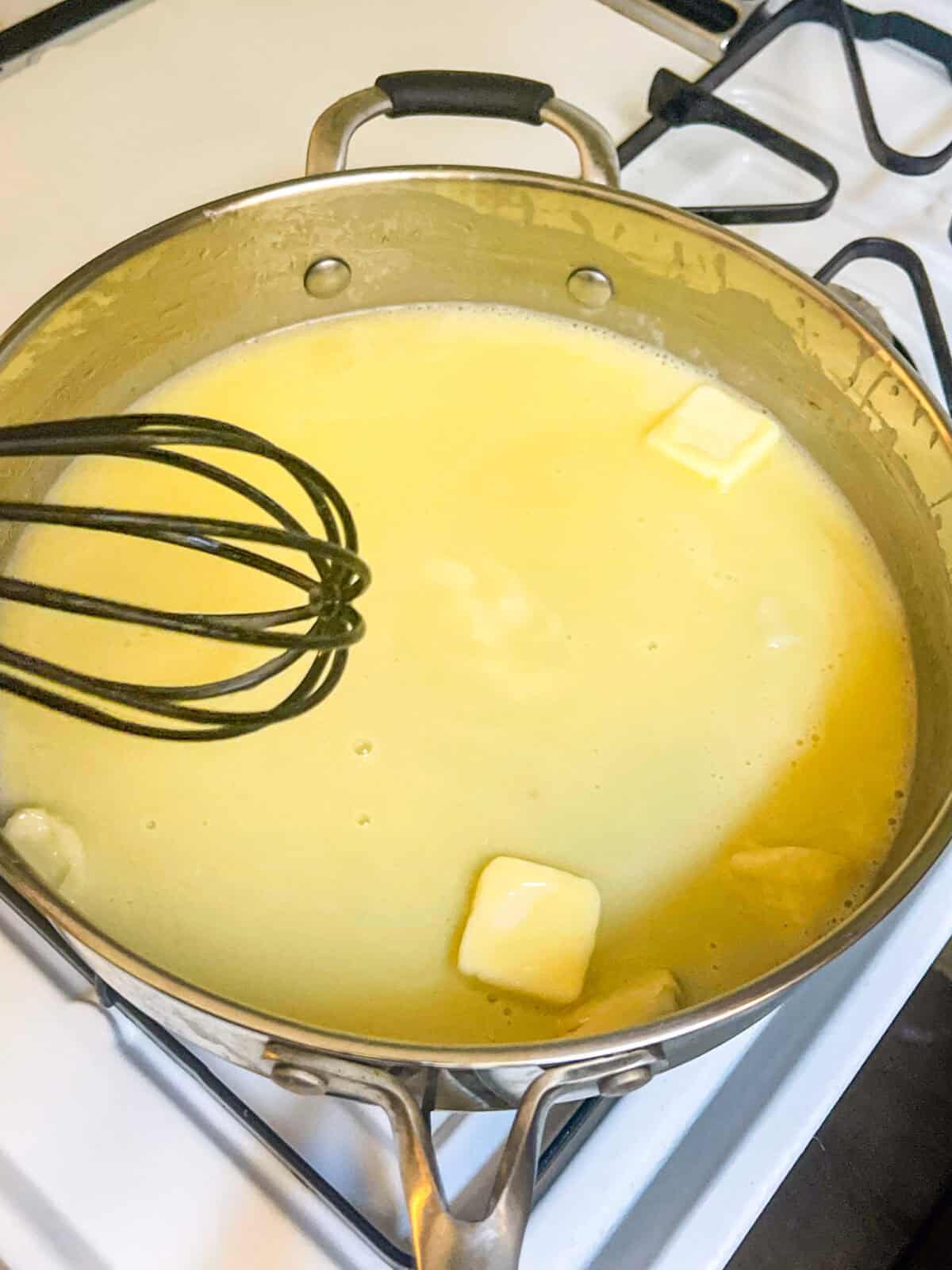 butter sauce whisked in a saucepan.