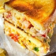 Lobster grilled cheese on a board.