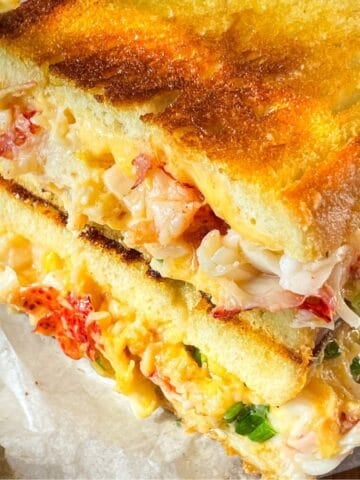 Lobster grilled cheese on a board.