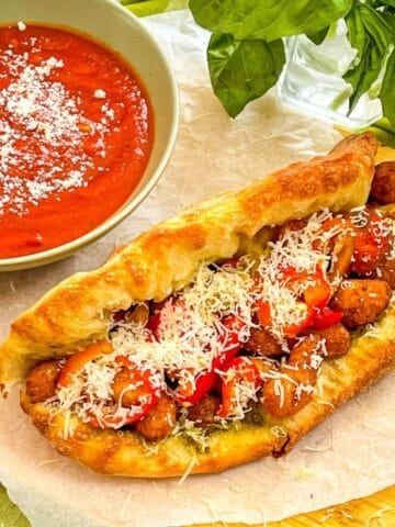 Shrimp Parm Sandwich On a table with a side of marinara.