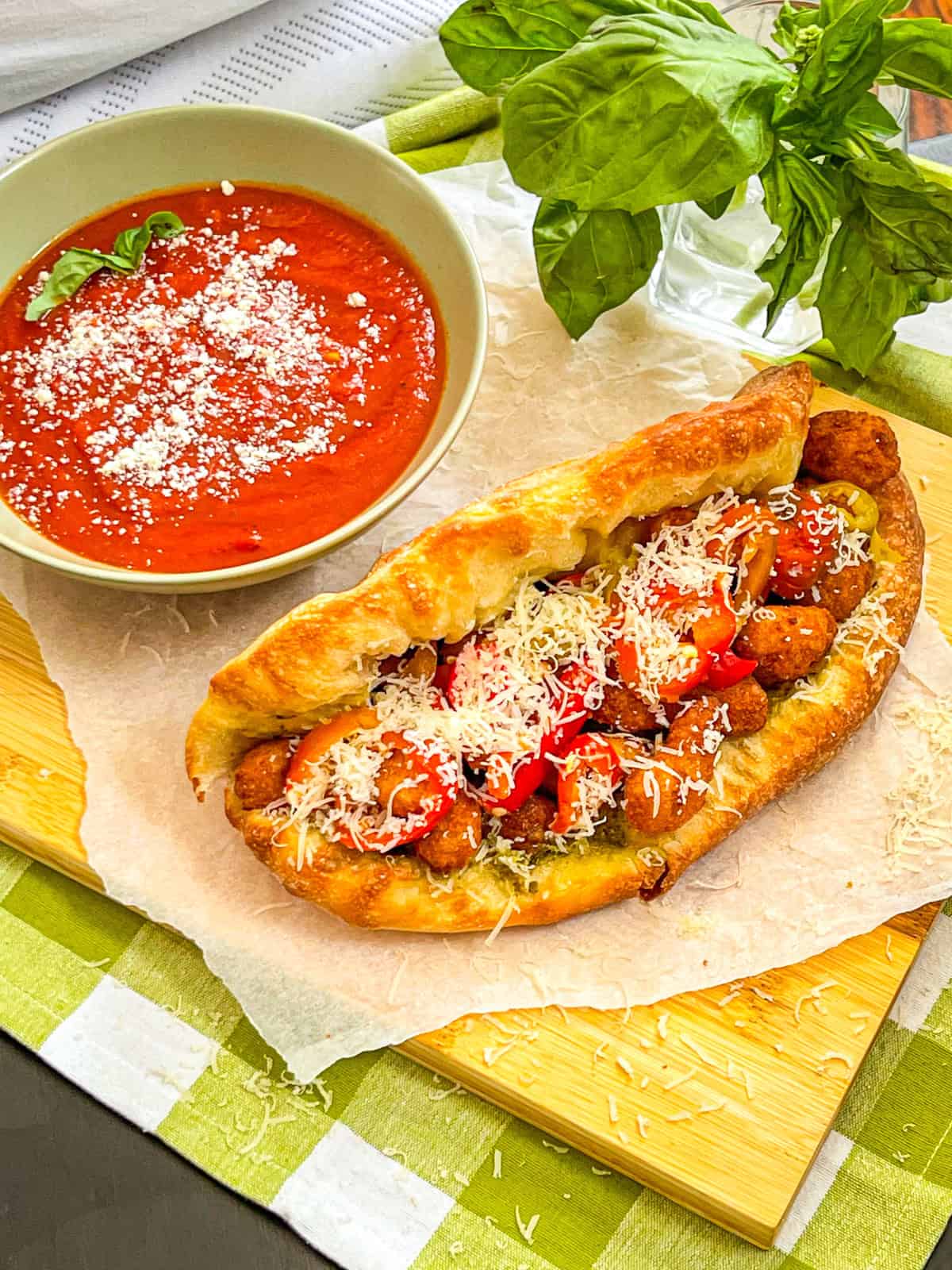 Shrimp Parm Sandwich On a table with a side of marinara.