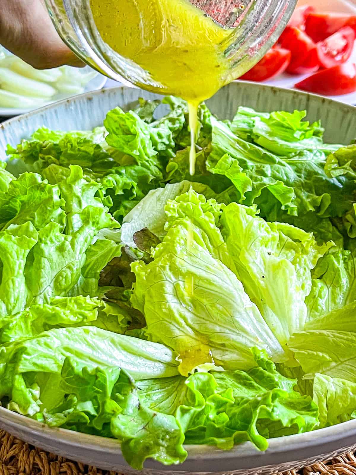 Dressing poured onto salad.