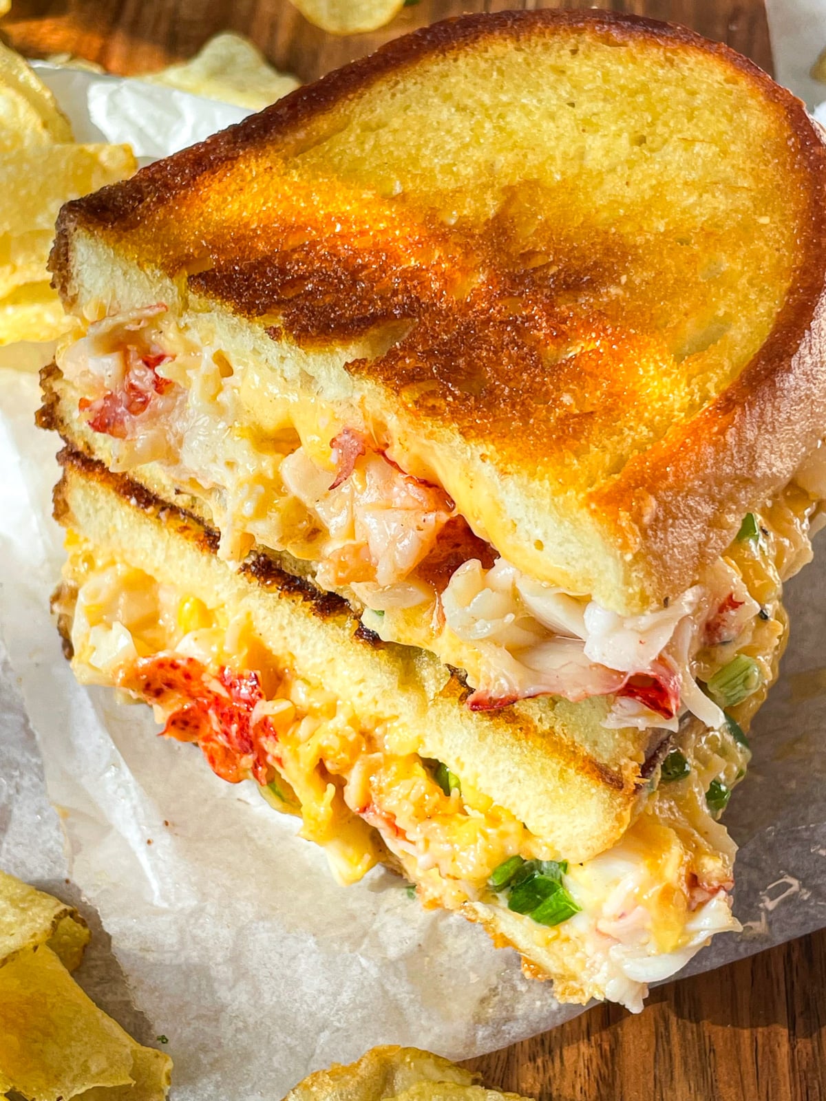 Lobster grilled cheese on a board.