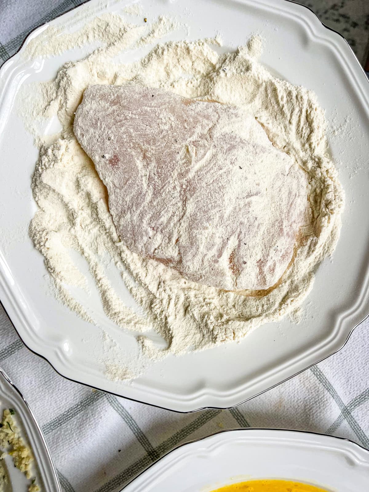 halibut cheek dusted an coated in flour.