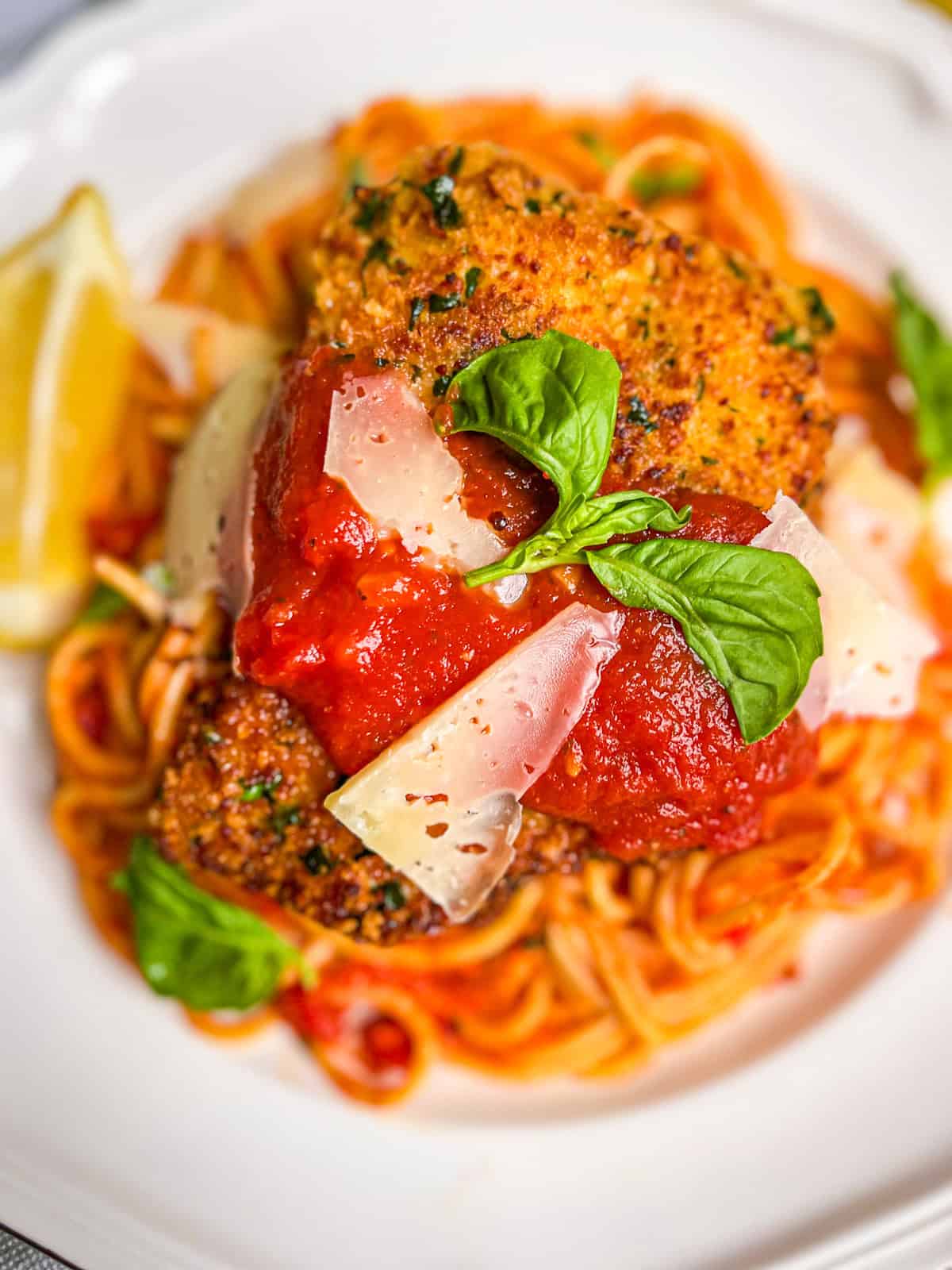 Crispy Halibut cheeks with marinara over a bed of pasta.