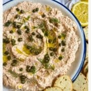 photo of smoked salmon dip swirled into a bowl and topped with capers, olive oil and dill.