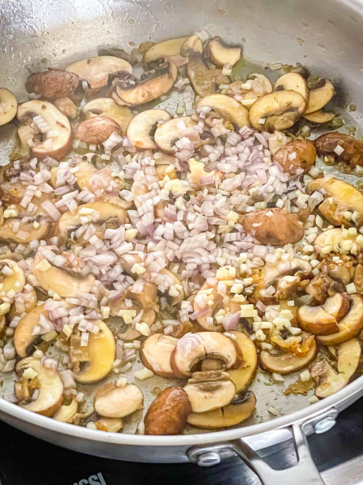Mushrooms garlic and shallots cooked in a skillet