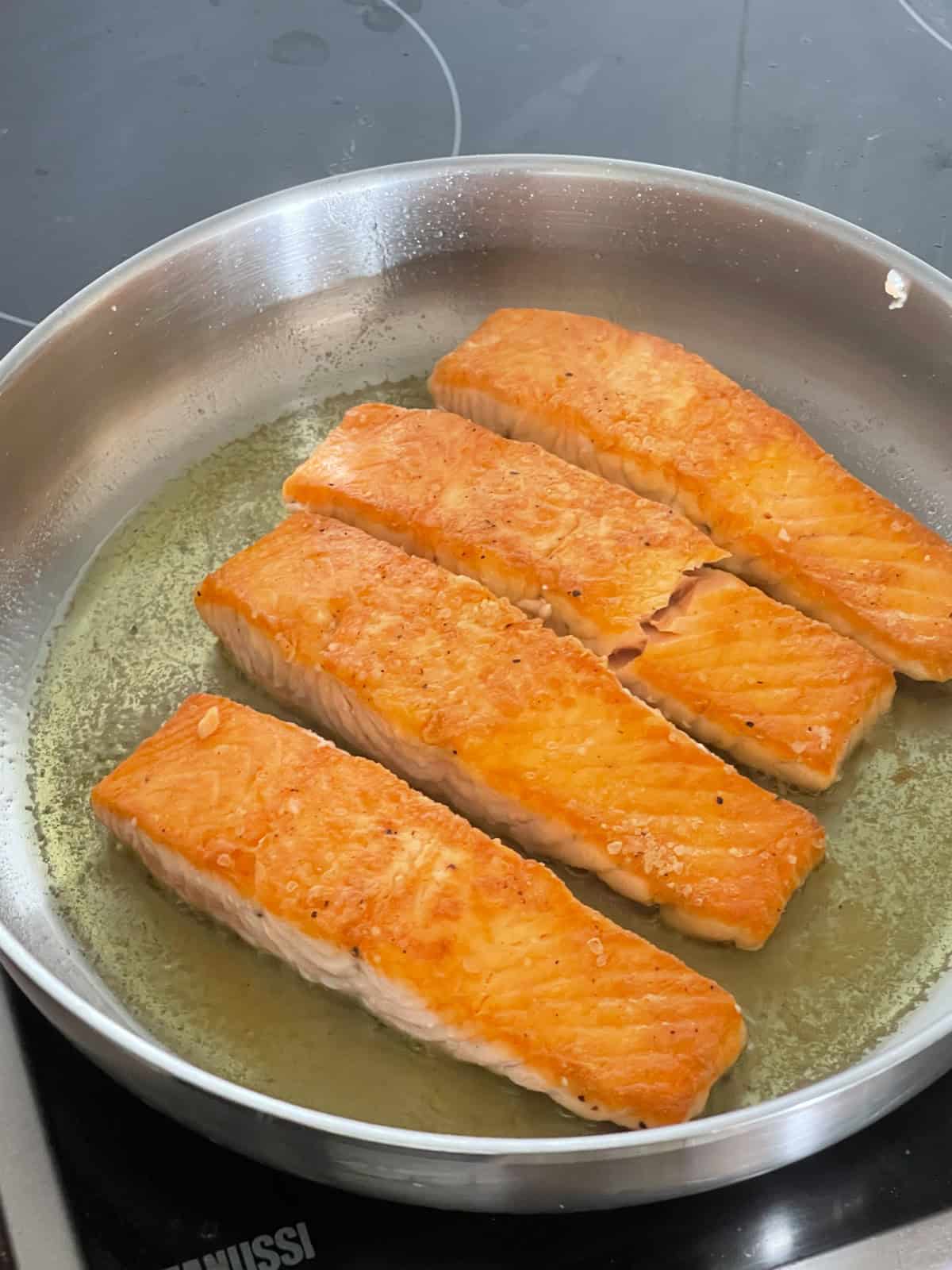 Salmon cooked in a skillet.