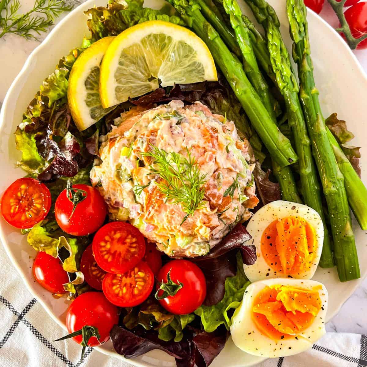 Hot Smoked Salmon Salad served over a leafy green salad.