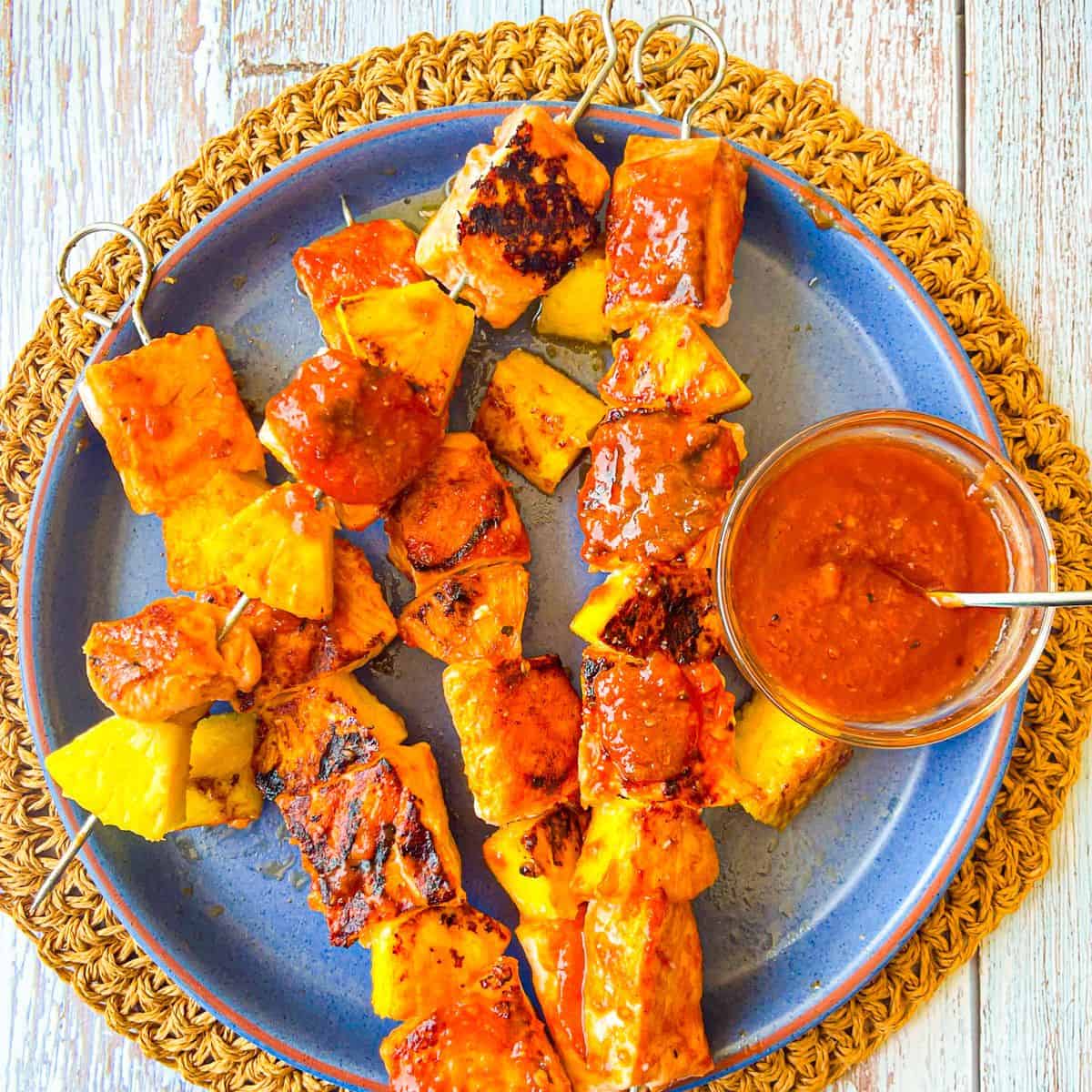 Pineapple Barbecue Sauce served with salmon and pineapple skewers.