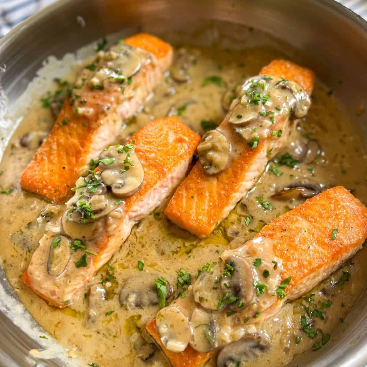 Salmon Marsala in a skillet with parsley.