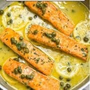 Salmon in lemon caper sauce in a skillet