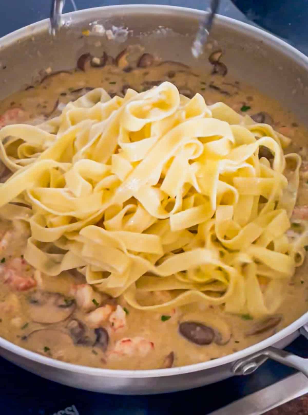 Pasta tossed in saucepan