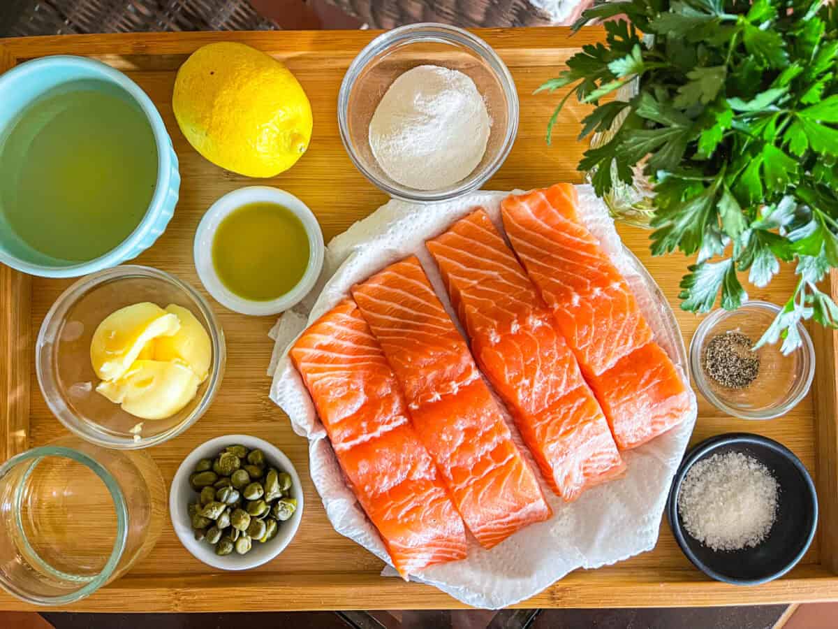 Ingredients for salmon piccata on a tray