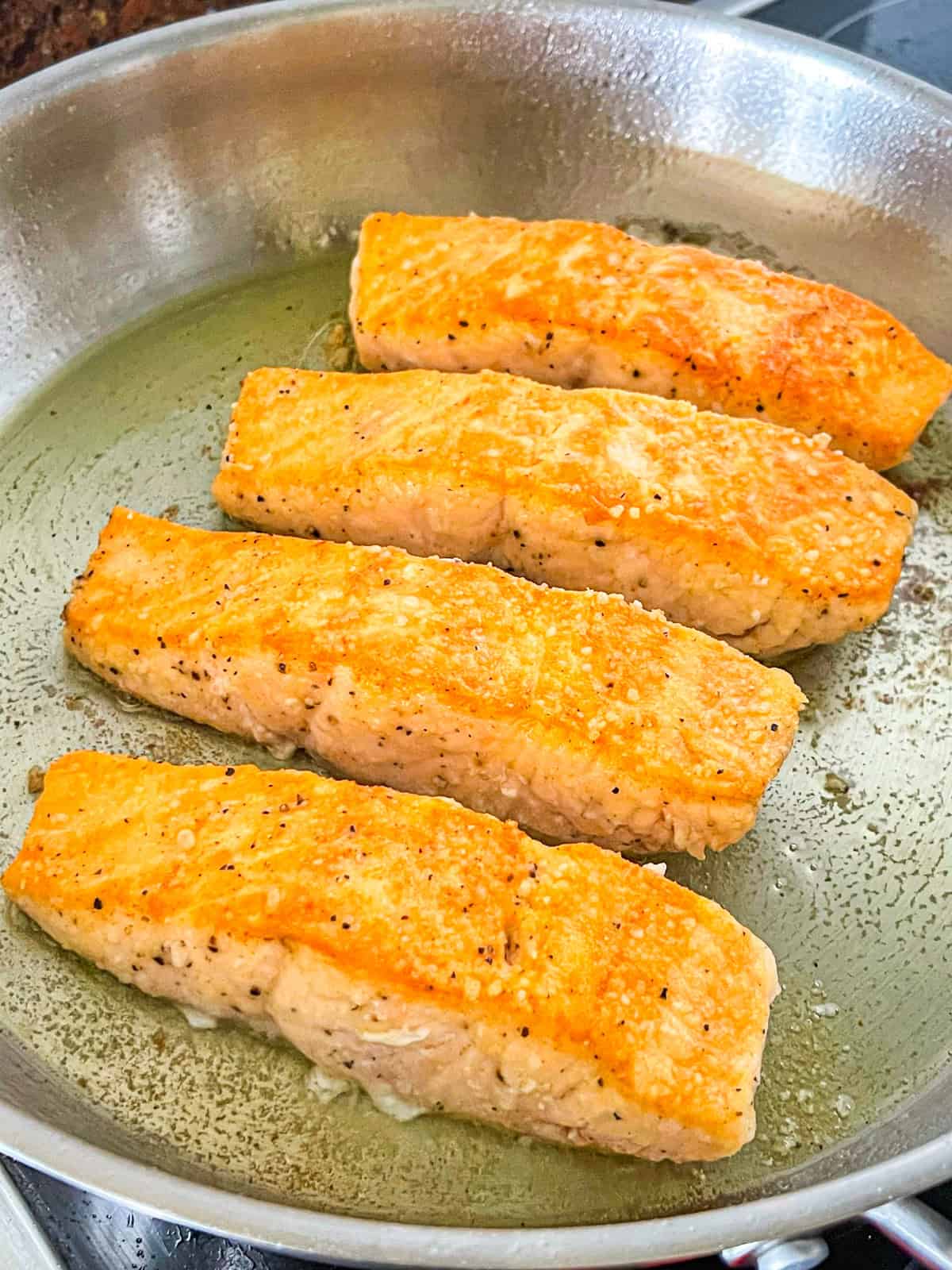 Salmon Piccata in a skillet.