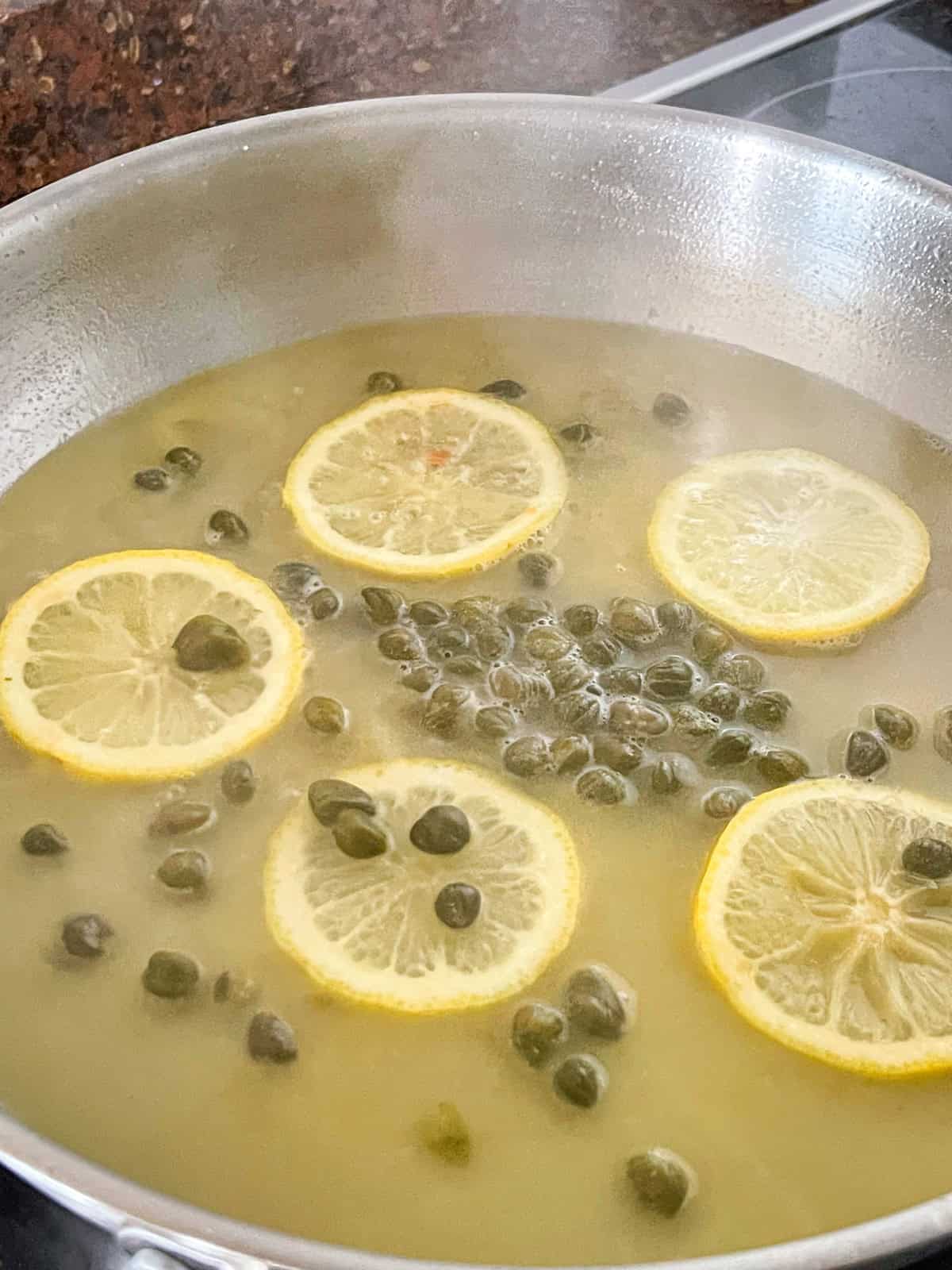 piccata sauce simmer in a skillet.