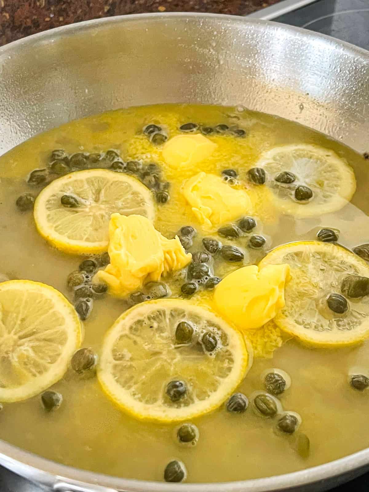 lemon butter sauce in a skillet.