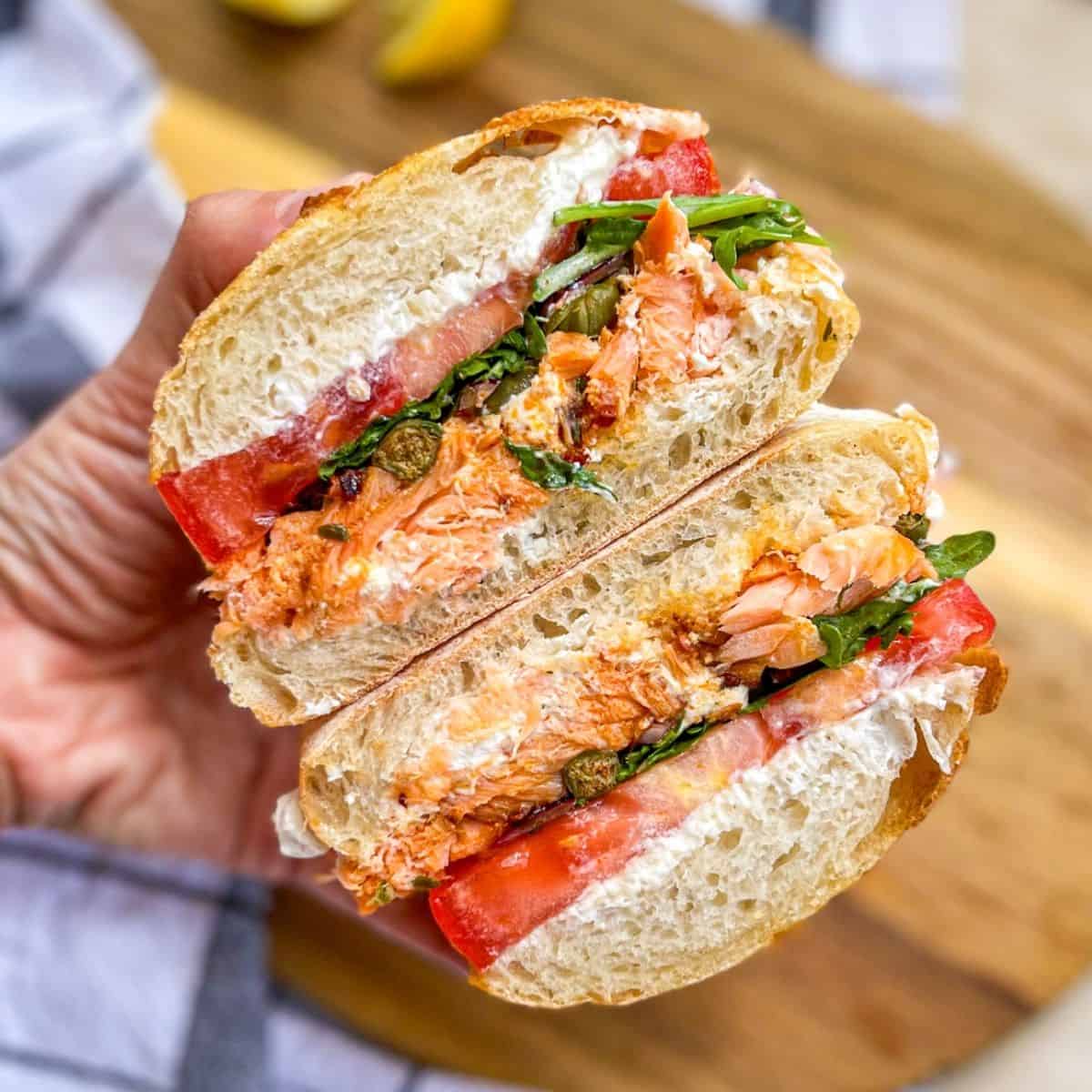 Hot Smoked Salmon Sandwich with ricotta, tomato, capers and arugula.