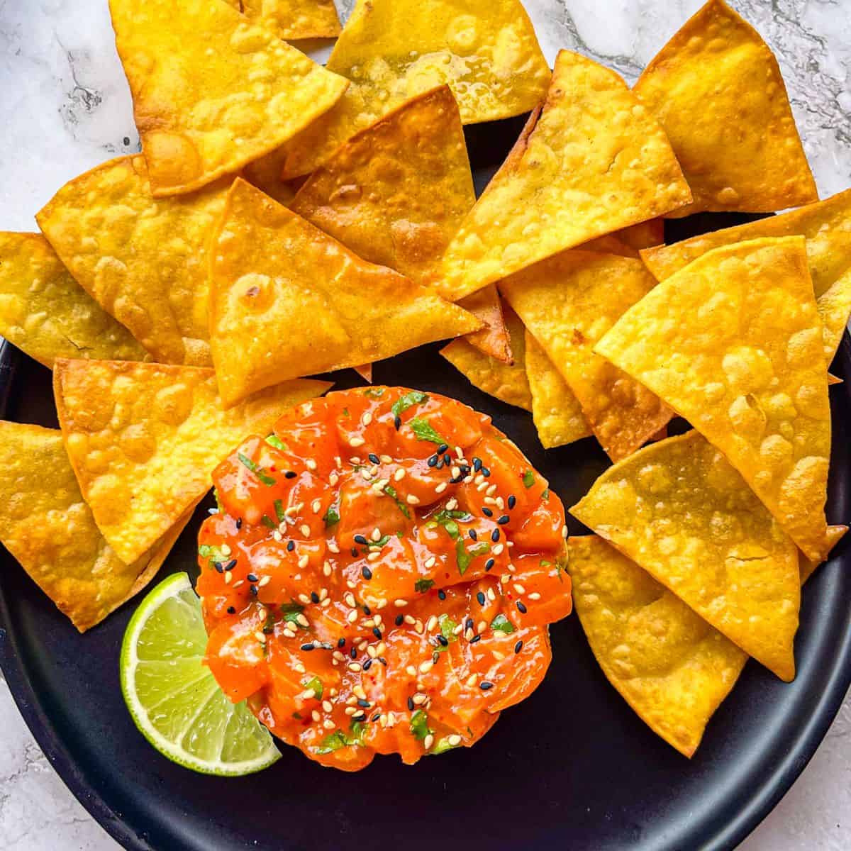 Spicy Salmon Recipe served over rice with crispy tortilla chips and limes.