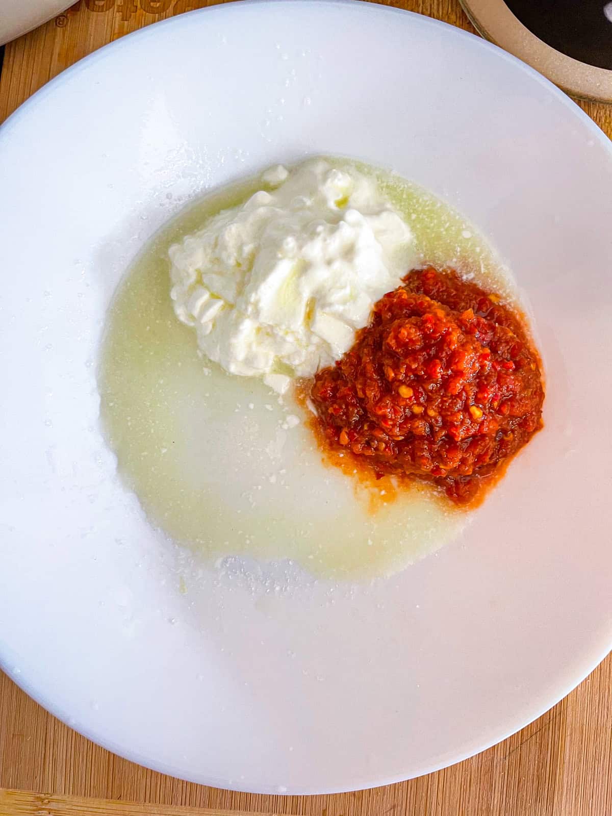 Yogurt and harissa in a bowl.