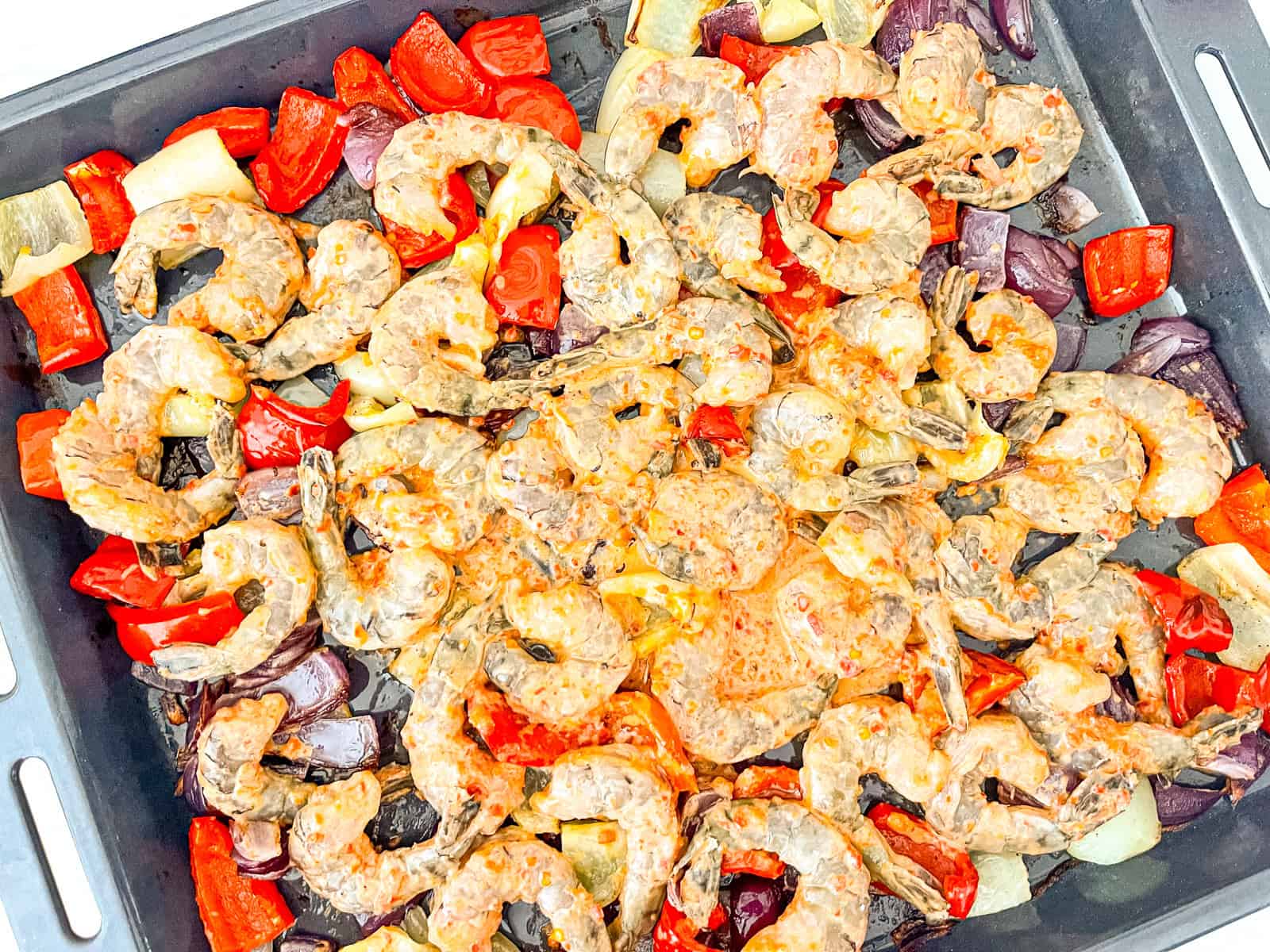 marinade shrimp over vegetables on a tray