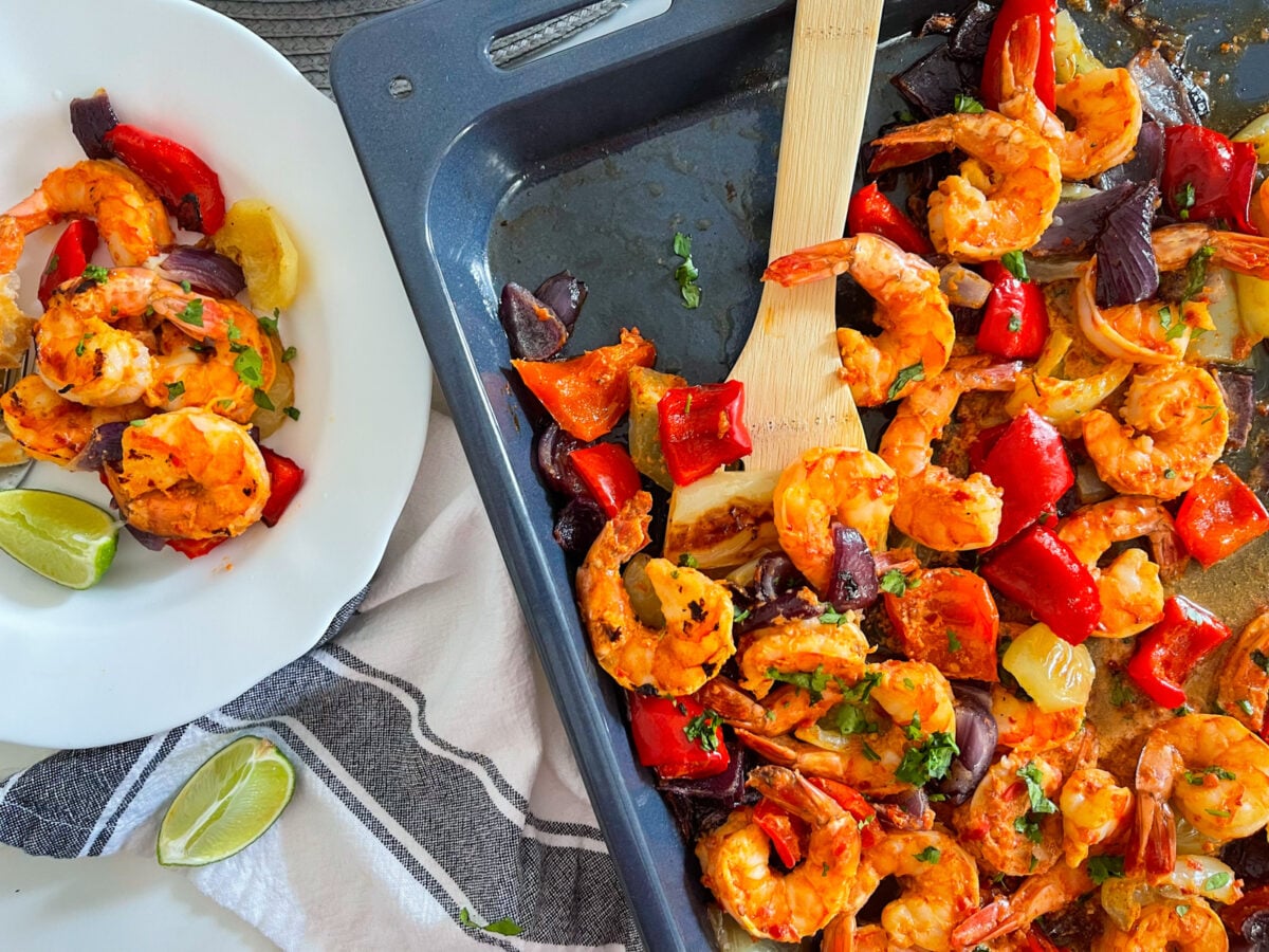 Harissa shrimp on a sheet pan and a bowl
