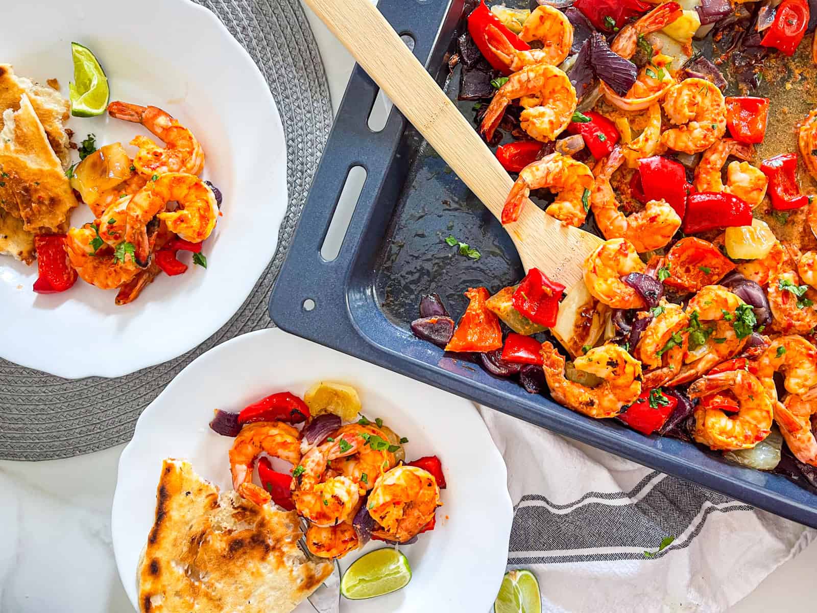 Harissa shrimp on a sheet pans and two bowl