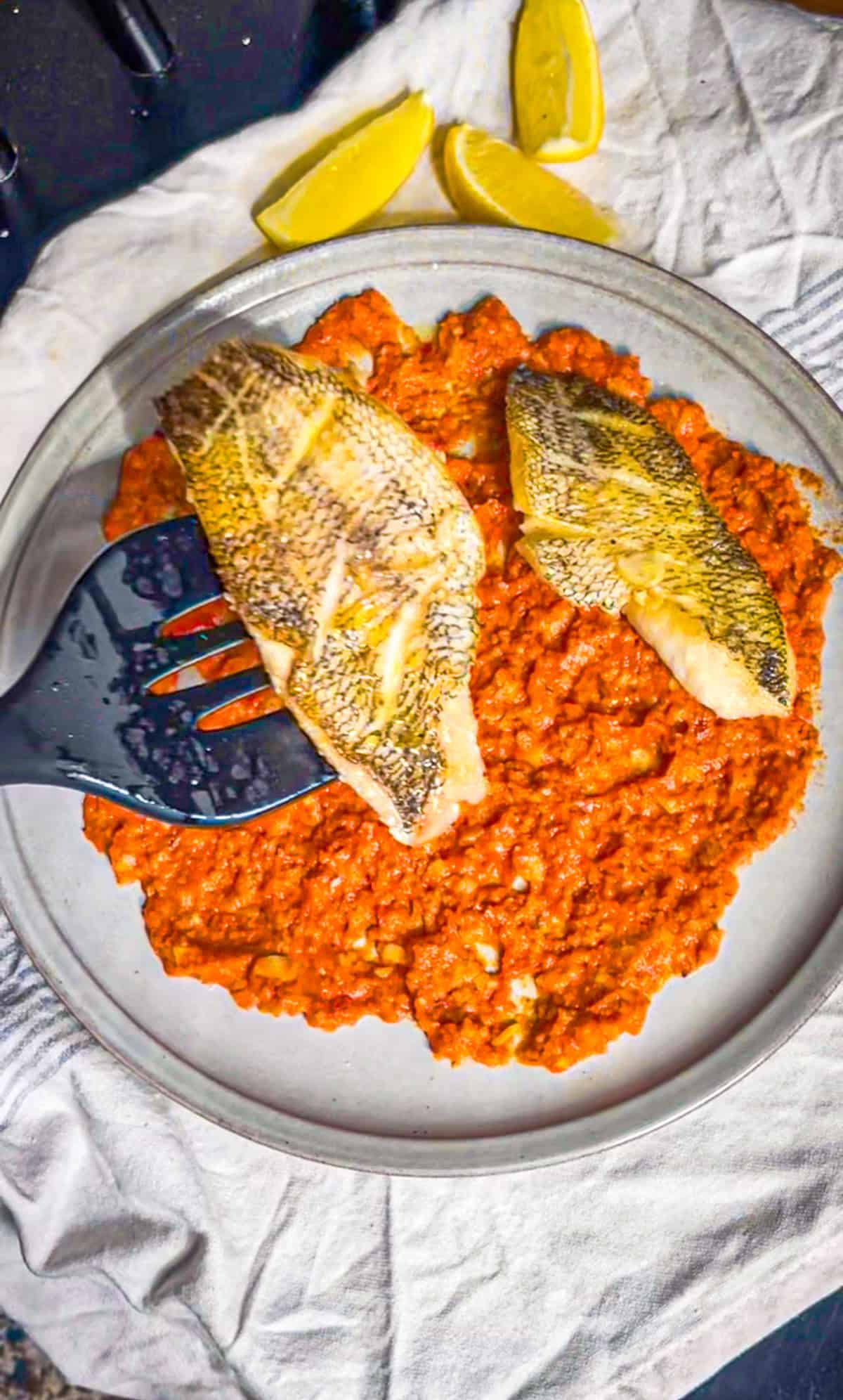 sea bass placed o na bed of romesco sauce