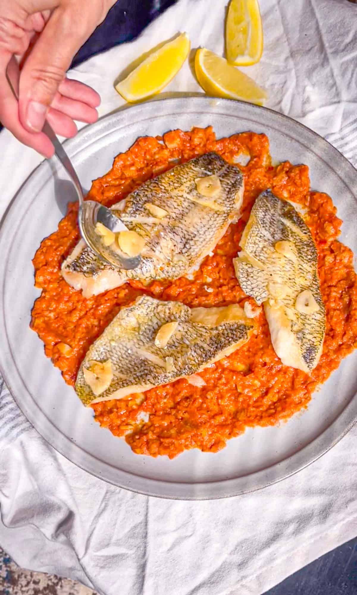 garlic spread over crispy sea bass