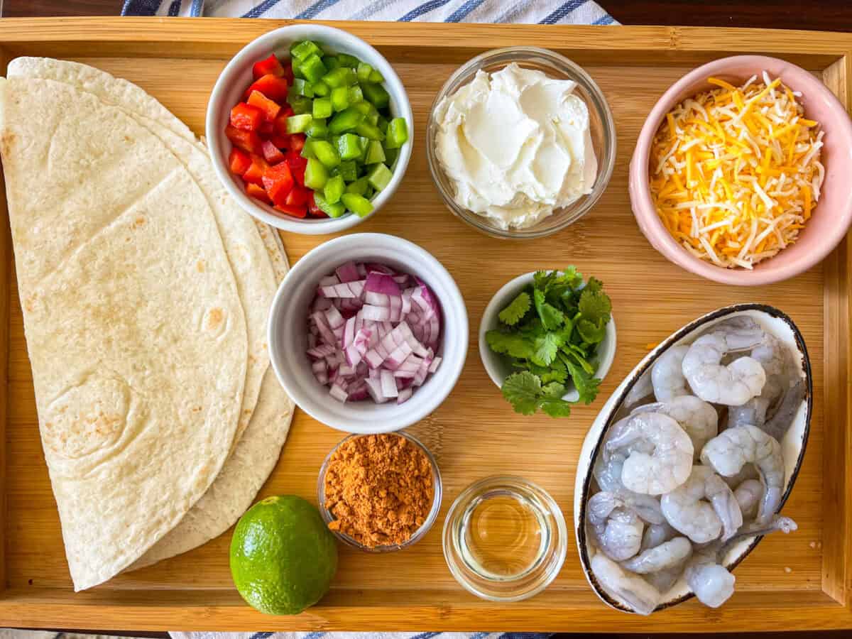 ingredients for shrimp chimichanga on a tray.