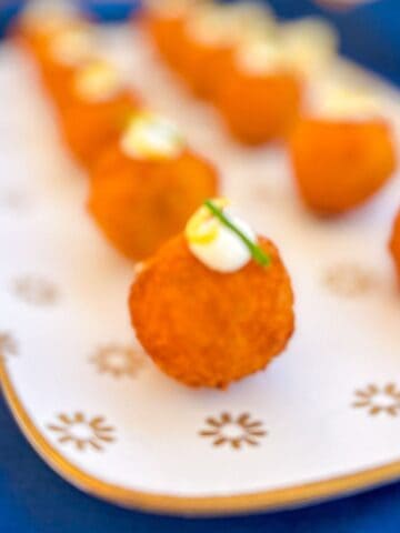 Salmon croquettes lined on a platter.