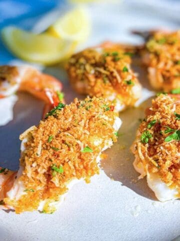 shrimp oreganata plated with lemon garnish.