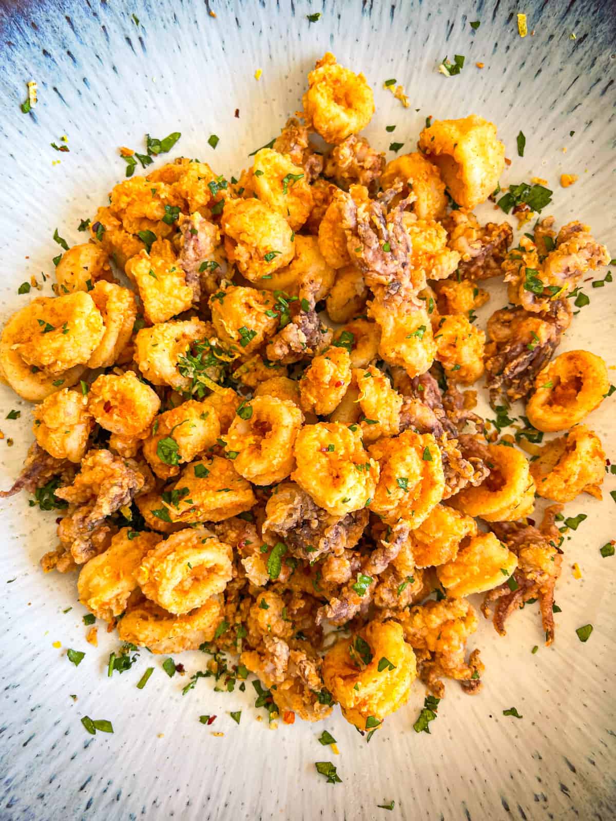 calamari tossed in a bowl with gremolata.