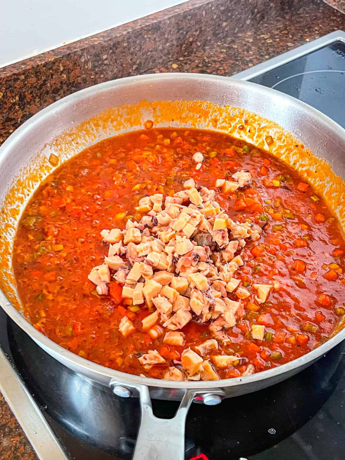 Chopped tinned octopus added to tomato sauce.